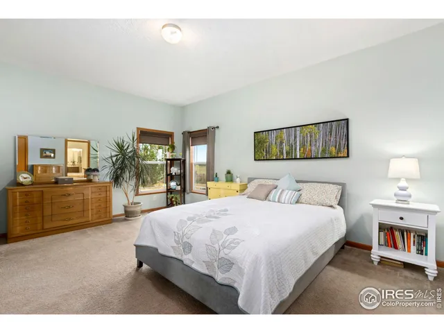 a bedroom with a bed a couch and dresser