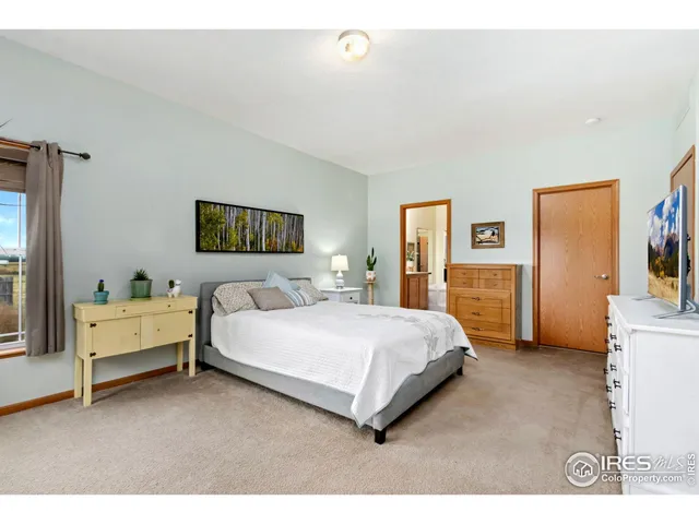 a bedroom with a bed and a desk