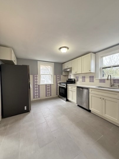 5 Alcott Street, Unit 2 Boston, MA 02134 - Photo 5 of 14 a large kitchen with a refrigerator a stove a sink a dishwasher and a refrigerator