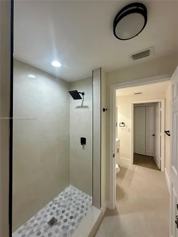a view of a bathroom with a glass door and shower