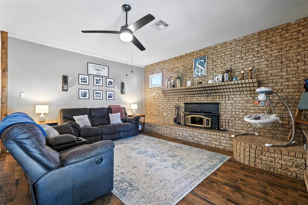 1017 Northwest 2nd Street Hamlin, TX 79520 - Photo 14 of 29 a living room with furniture and a fireplace
