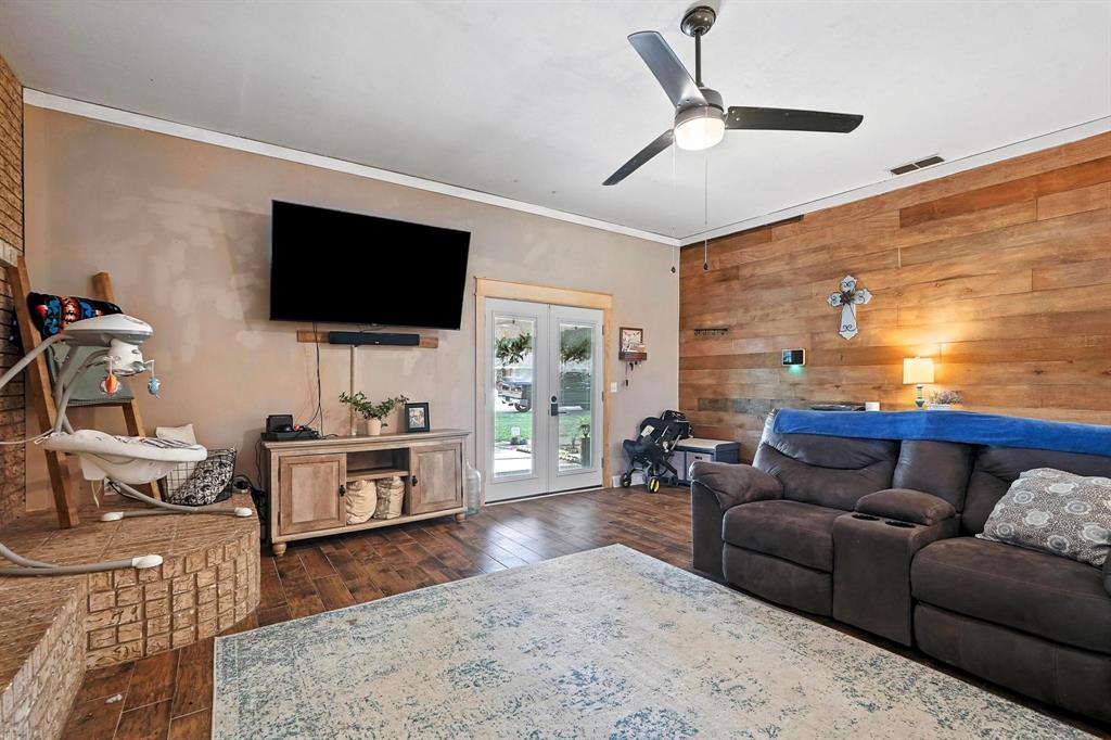 1017 Northwest 2nd Street Hamlin, TX 79520 - Photo 17 of 29 a living room with furniture and a flat screen tv