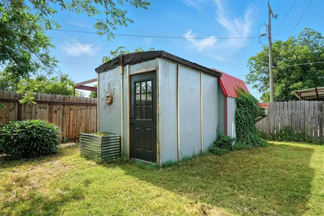 a backyard of a house with plants and tree