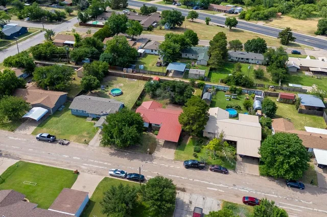 an aerial view of house with yard swimming pool and outdoor seating