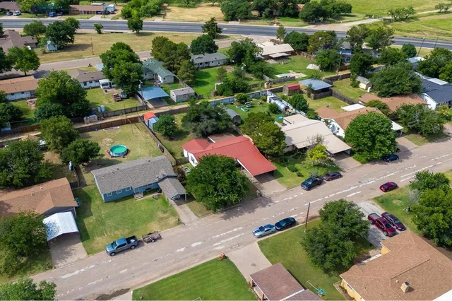 an aerial view of a house with a yard