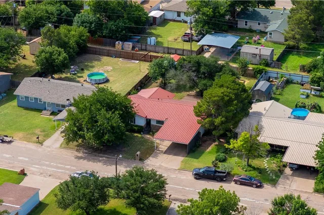 an aerial view of a house with a swimming pool yard and outdoor seating