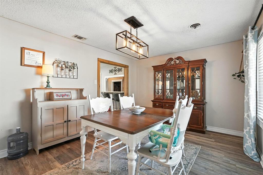 1017 Northwest 2nd Street Hamlin, TX 79520 - Photo 6 of 29 a view of a dining room with furniture window and wooden floor