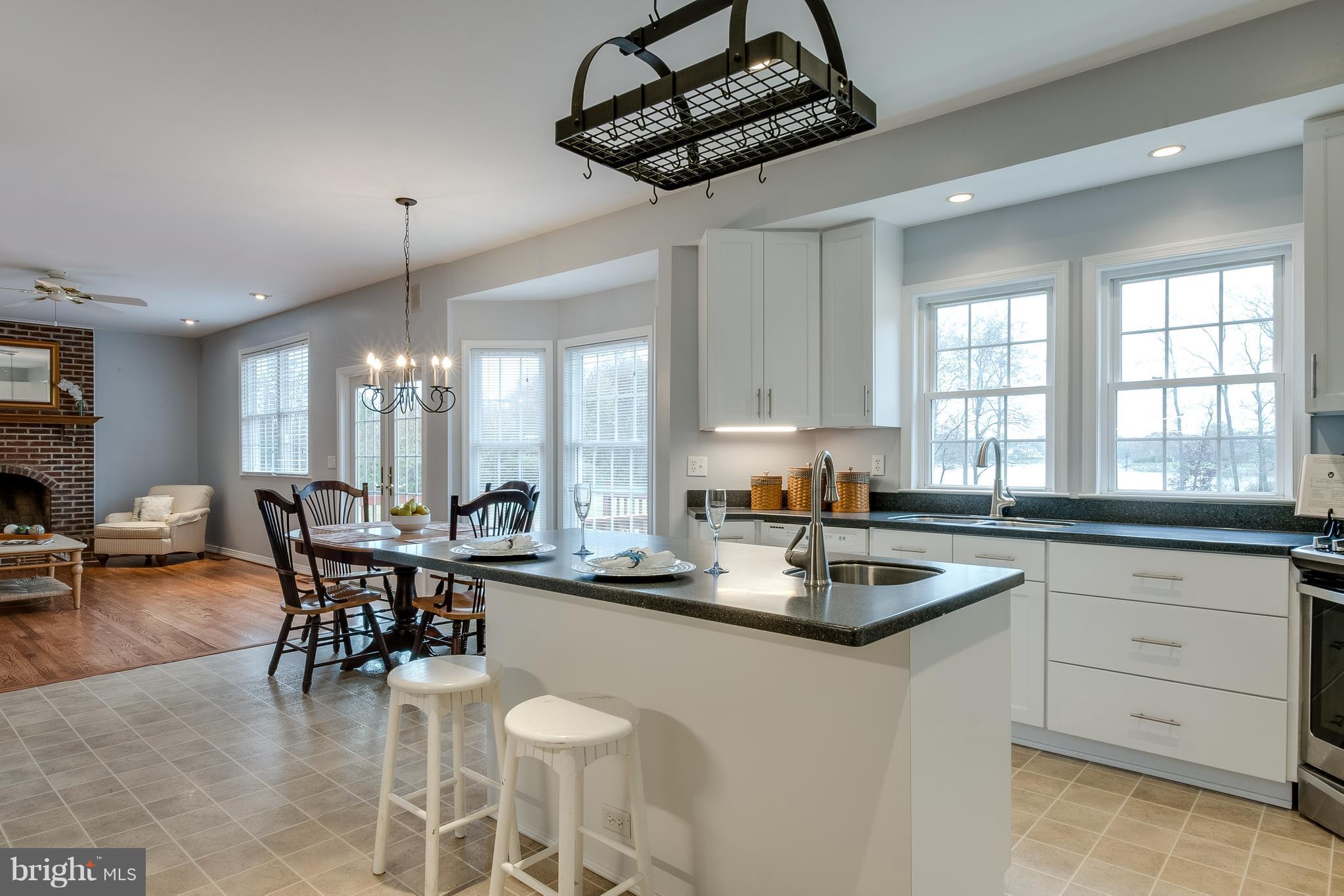 124 Chews Manor Road Stevensville, MD 21666 - Photo 14 of 30 Kitchen with crisp white cabinets & corian