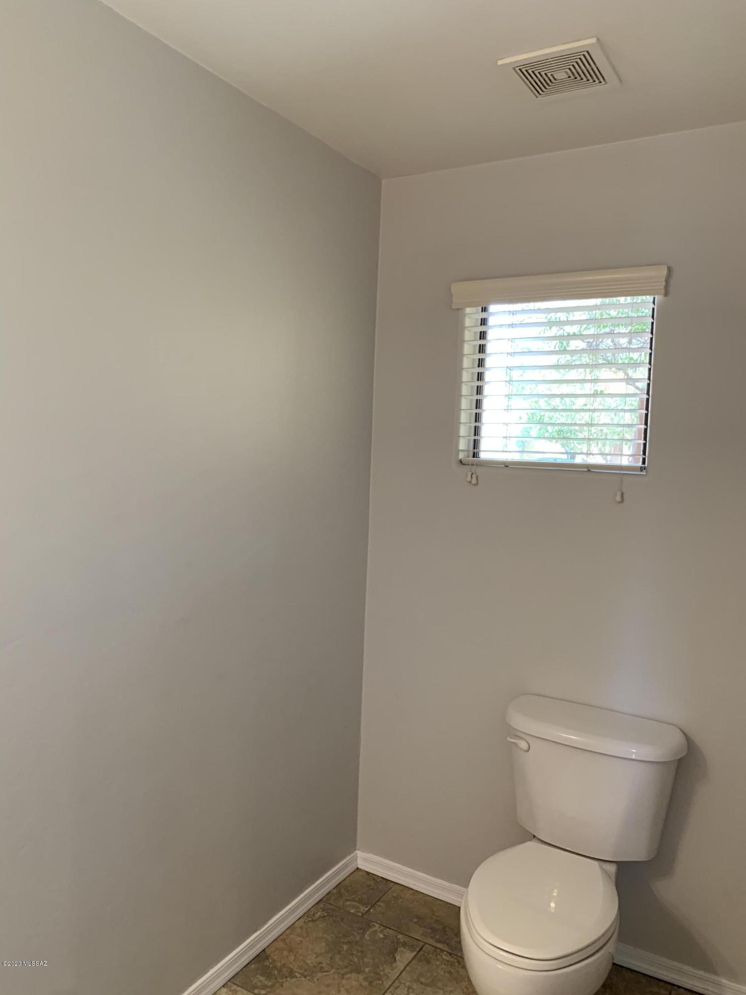 4181 North Fortune Loop Tucson, AZ 85719 - Photo 18 of 39 a white toilet sitting next to a window