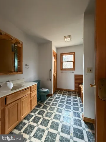 a view of a bathroom with a sink and a mirror