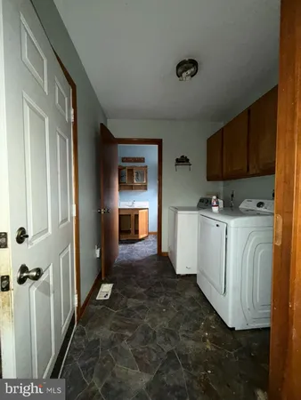 a view of a utility room with cabinets