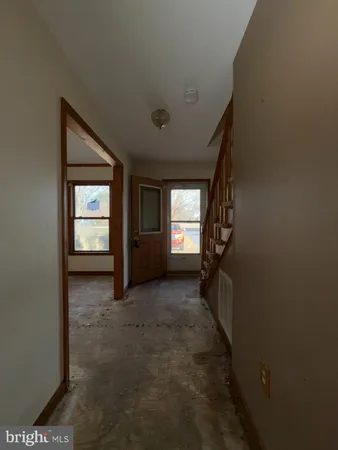a view of hallway with window and stairs