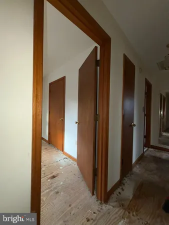a view of a hallway with wooden shelves