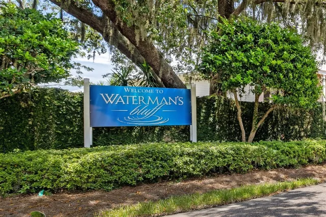 a view of a house with a yard and pathway