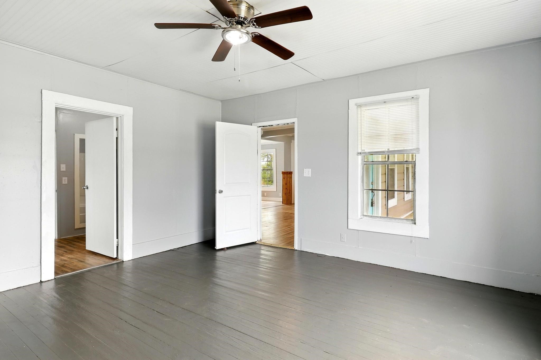 307 Shepard Lane Brenham, TX 77833 - Photo 12 of 47 a view of an empty room with wooden floor and a window