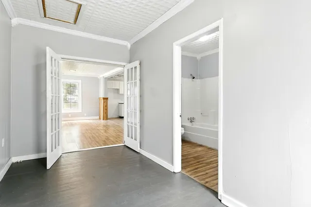 a view of a hallway with wooden floor