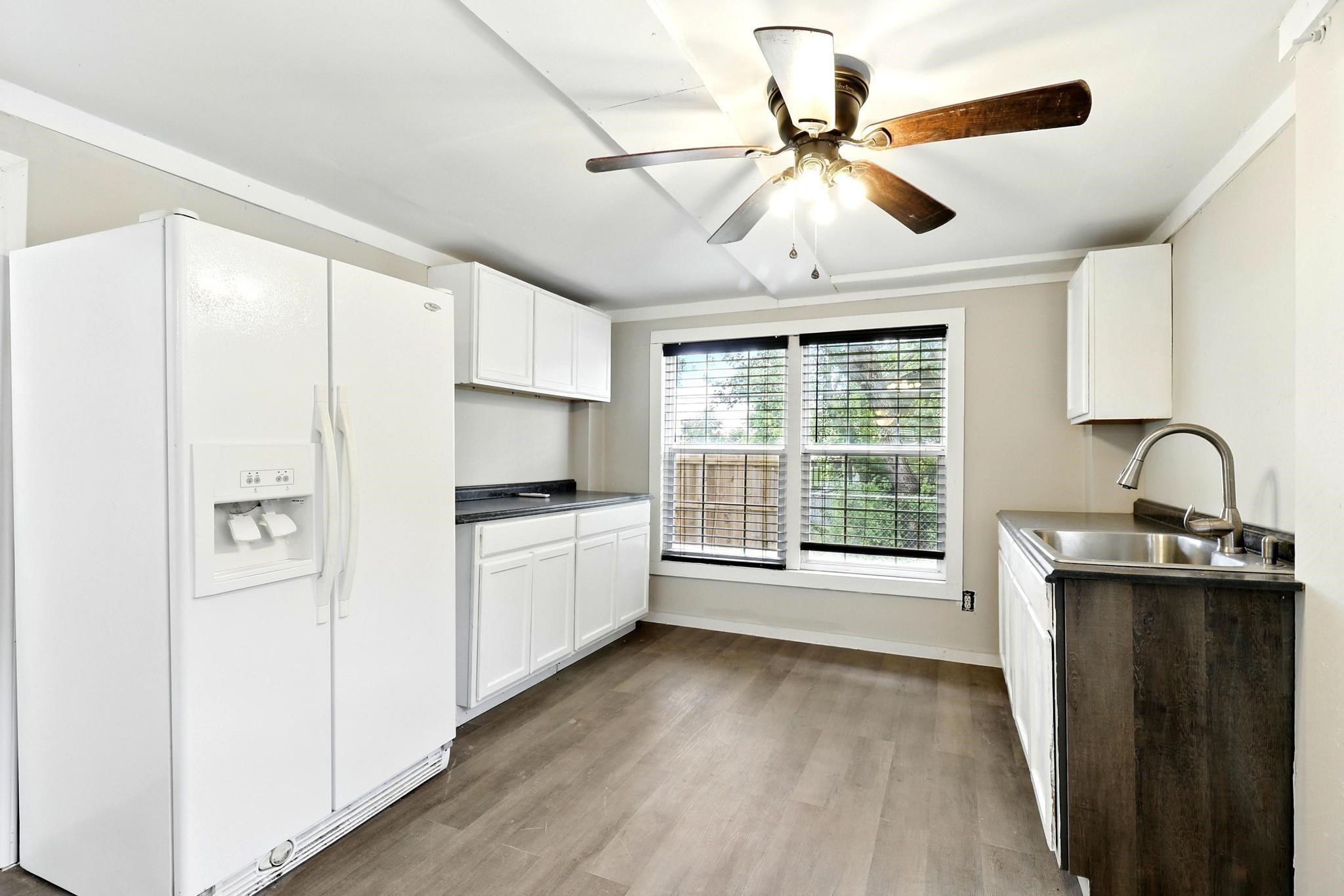 307 Shepard Lane Brenham, TX 77833 - Photo 18 of 47 a kitchen with a refrigerator and a sink