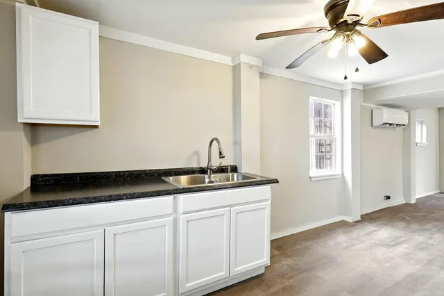 a kitchen with a sink and cabinets
