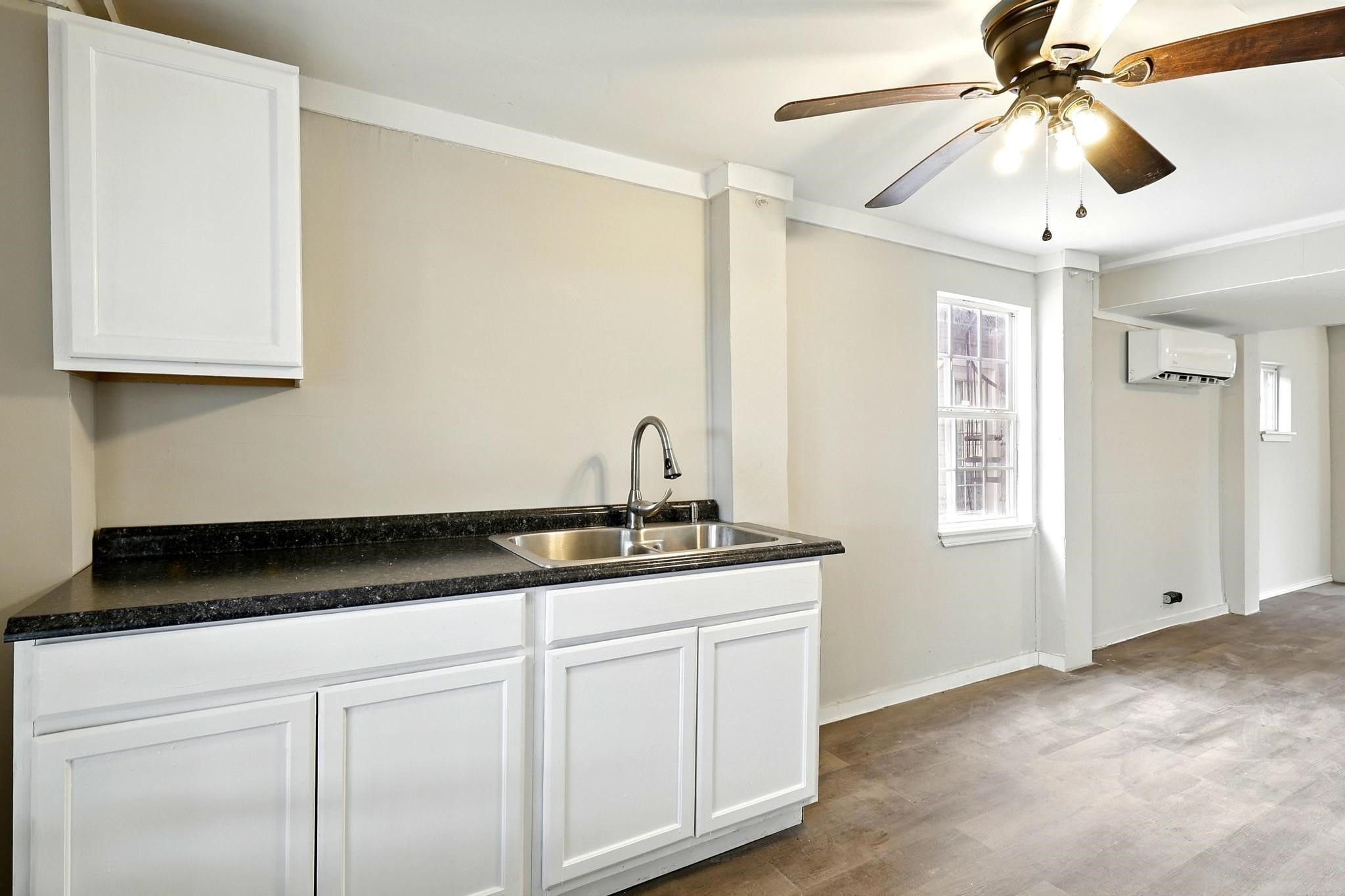 307 Shepard Lane Brenham, TX 77833 - Photo 19 of 47 a kitchen with a sink and cabinets