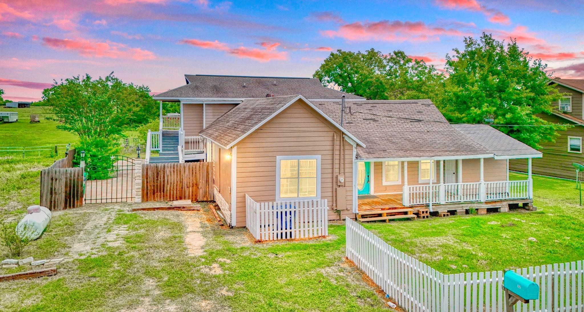 307 Shepard Lane Brenham, TX 77833 - Photo 2 of 47 a view of a house with a yard and a garden