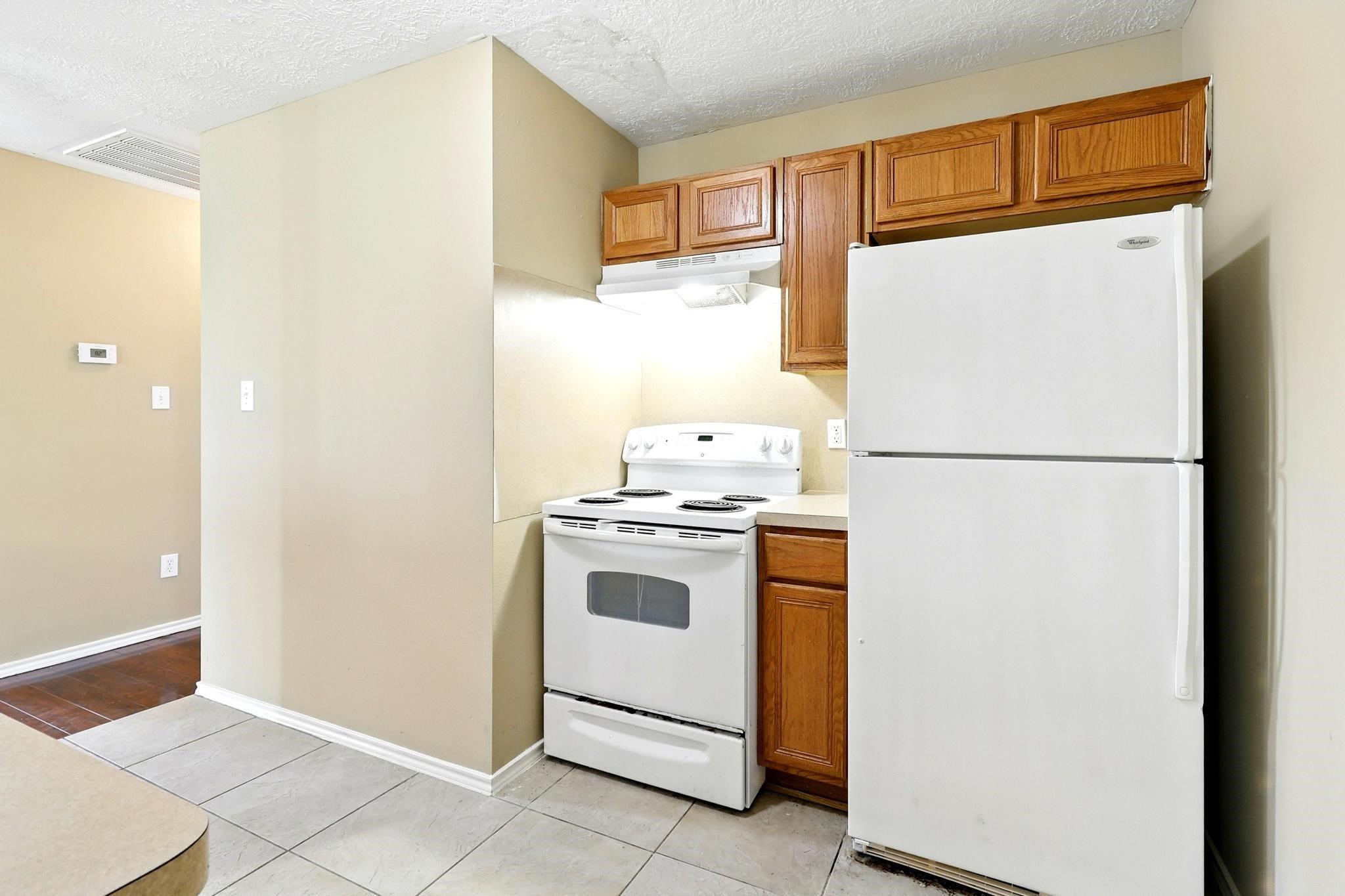 307 Shepard Lane Brenham, TX 77833 - Photo 28 of 47 a kitchen with a refrigerator and a stove