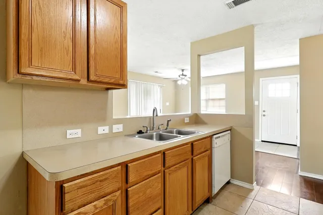 a kitchen with stainless steel appliances granite countertop a sink and a cabinets