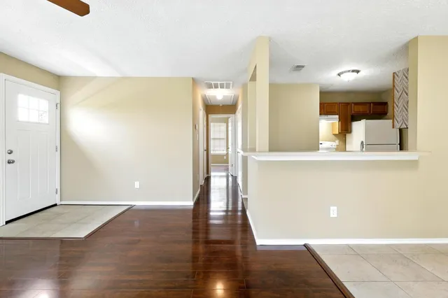 a view of a living room with wooden floor