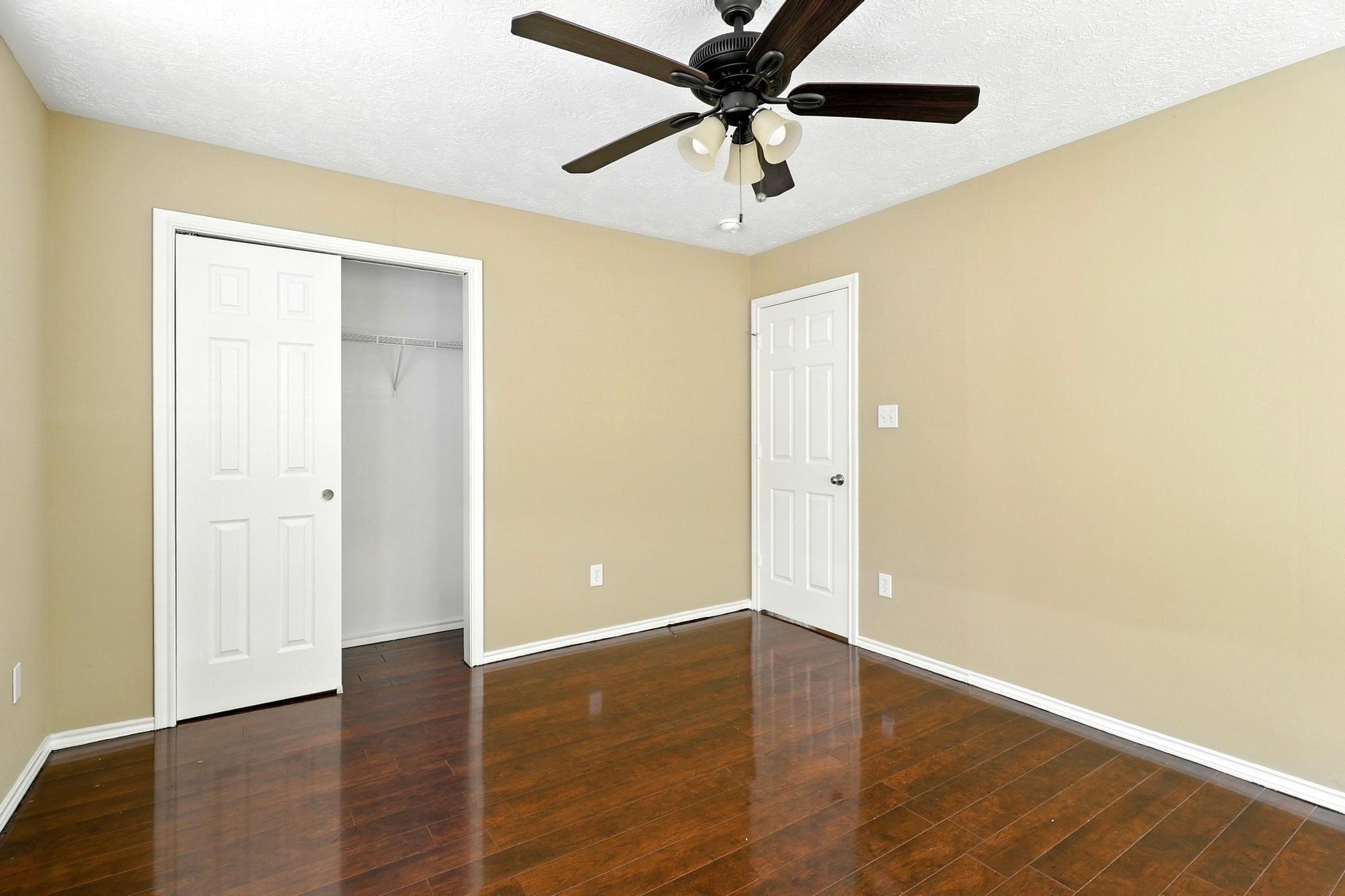 307 Shepard Lane Brenham, TX 77833 - Photo 37 of 47 an empty room with wooden floor and a ceiling fan