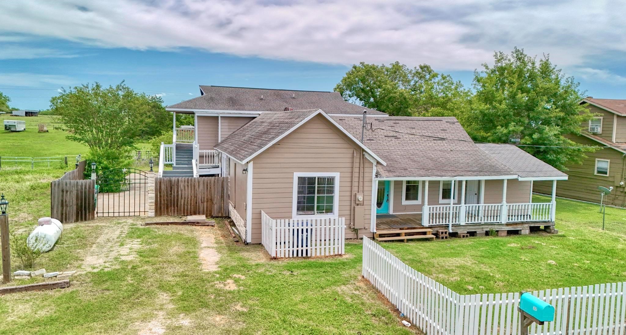307 Shepard Lane Brenham, TX 77833 - Photo 38 of 47 a view of a house with a yard and potted plants