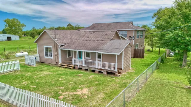 a aerial view of a house with a yard table and chairs