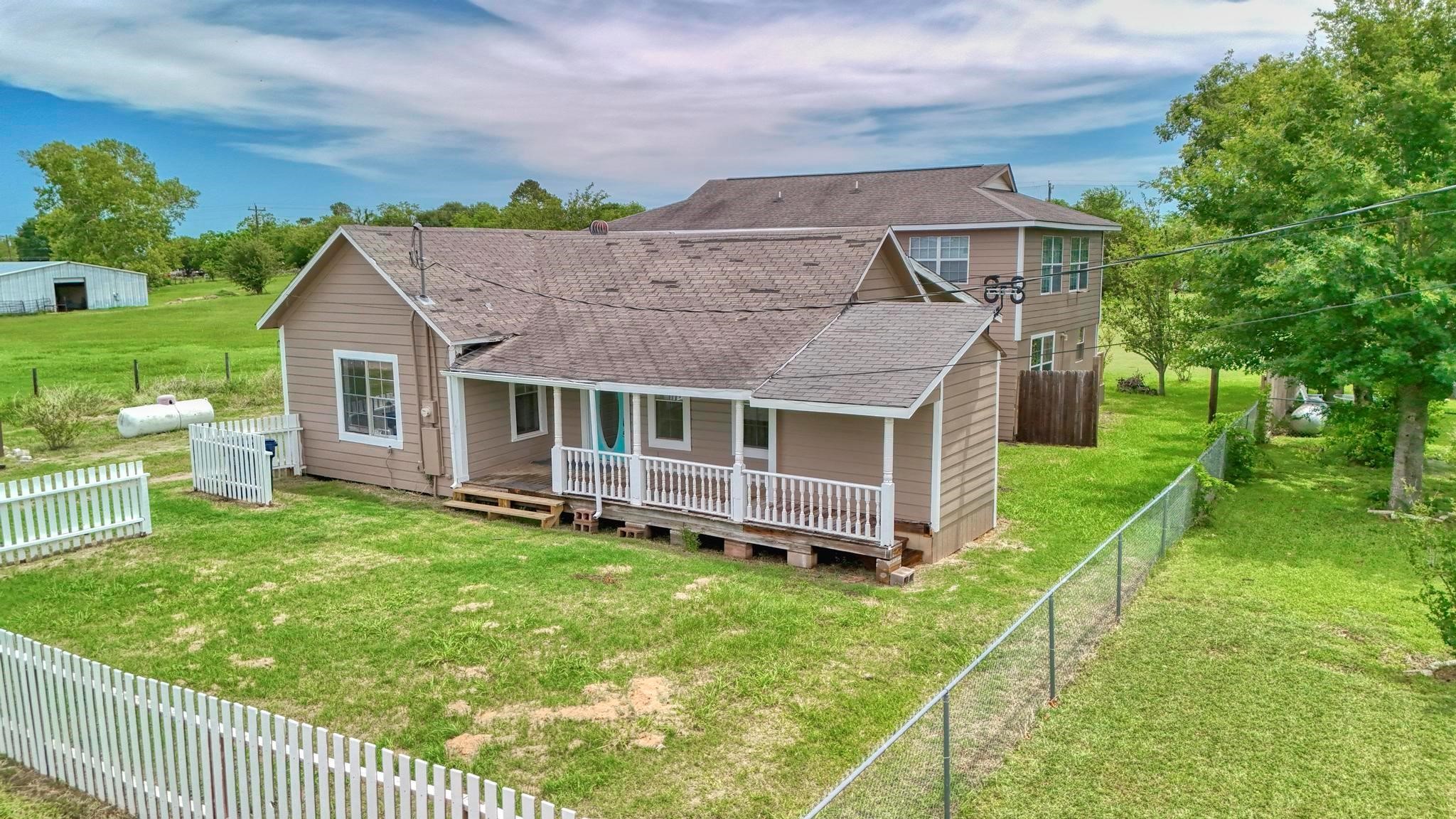 307 Shepard Lane Brenham, TX 77833 - Photo 39 of 47 a aerial view of a house with a yard table and chairs