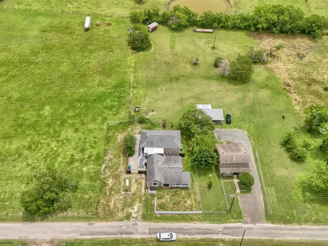 an aerial view of residential house with outdoor space and lake view