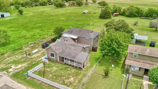 an aerial view of a house with a yard