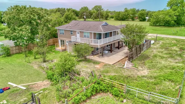 a aerial view of a house with swimming pool and green space