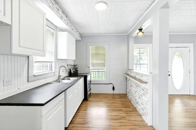 a kitchen with granite countertop a stove and a sink