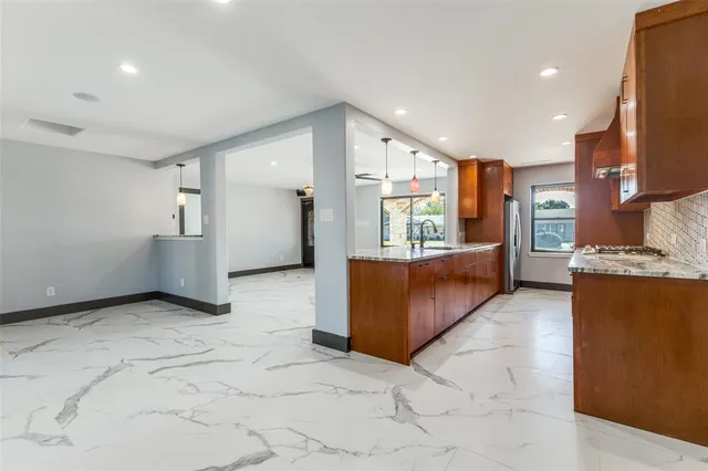 a view of a livingroom with a ceiling fan and window