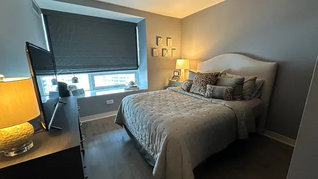 a bedroom with a bed and wooden floor