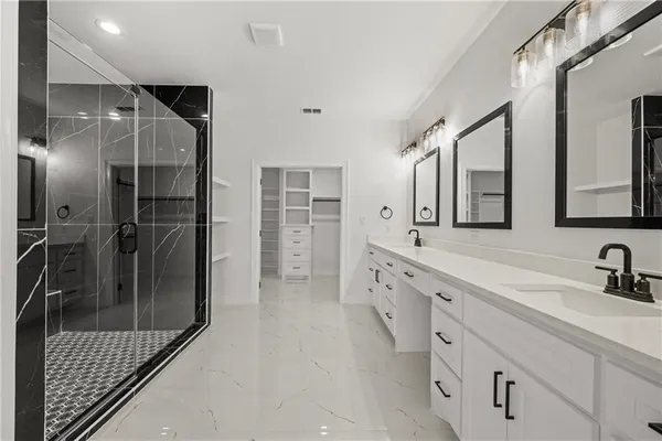 a bathroom with a shower sink and mirror