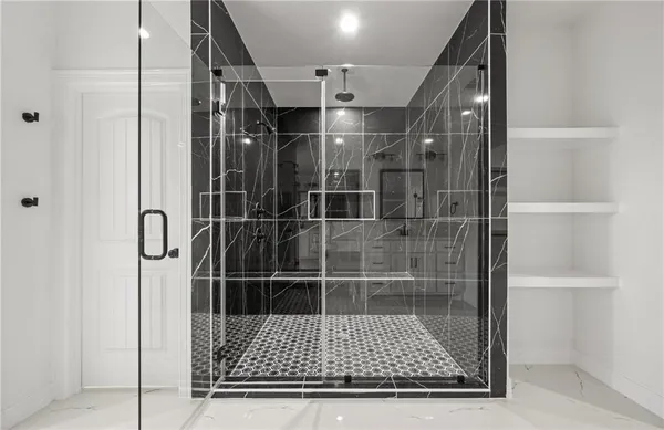 a bathroom with a glass shower door