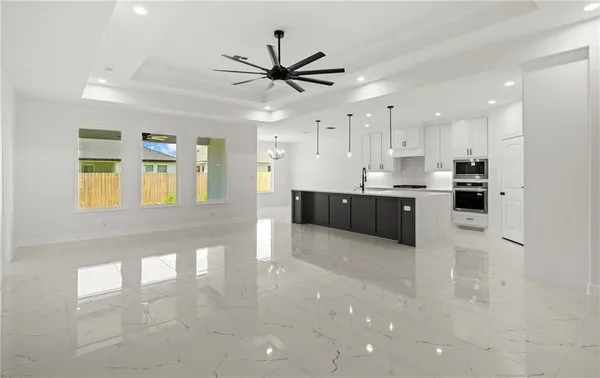 a view of kitchen with sink and refrigerator