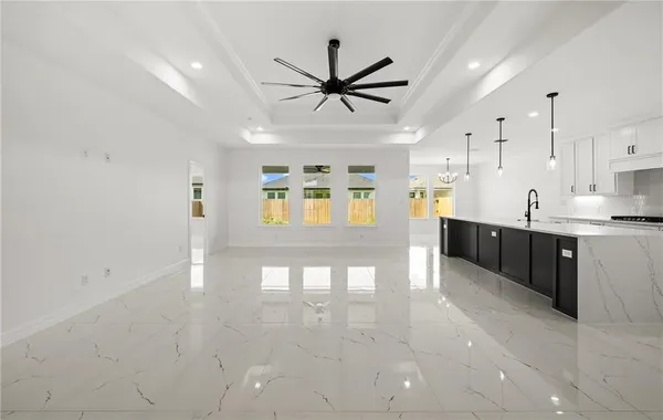 a kitchen with stainless steel appliances kitchen island granite countertop a sink a stove and a window