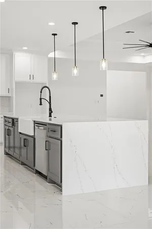 a kitchen with a sink a stove and cabinets