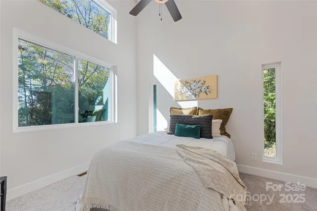 a bed sitting in a bedroom next to a window