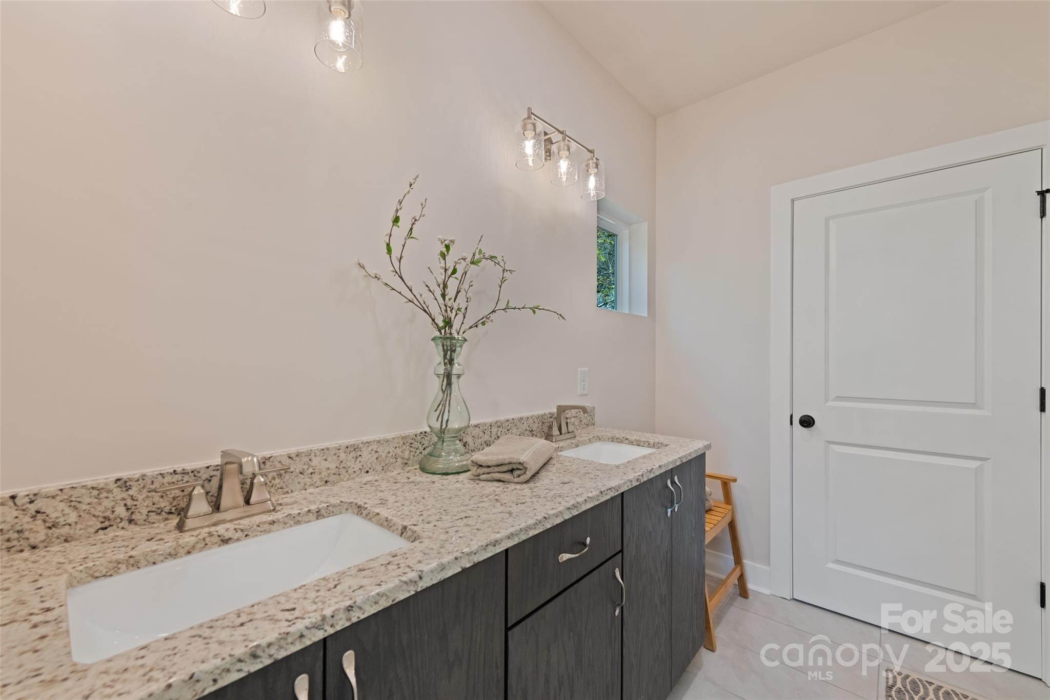 1807 Fisher Crk Road Sylva, NC 28779 - Photo 13 of 37 a bathroom with a granite countertop sink and a mirror