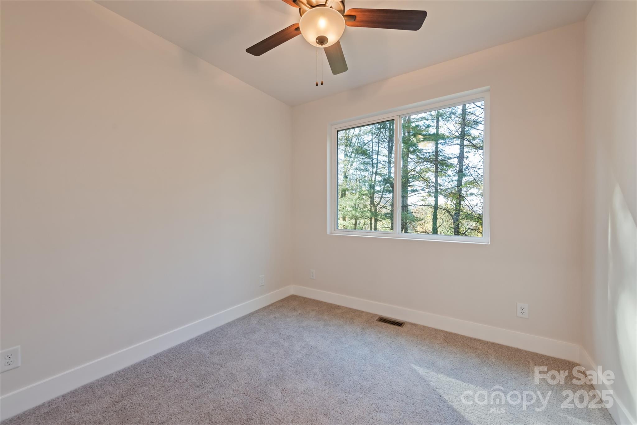 1807 Fisher Crk Road Sylva, NC 28779 - Photo 15 of 37 an empty room with a window and a fan