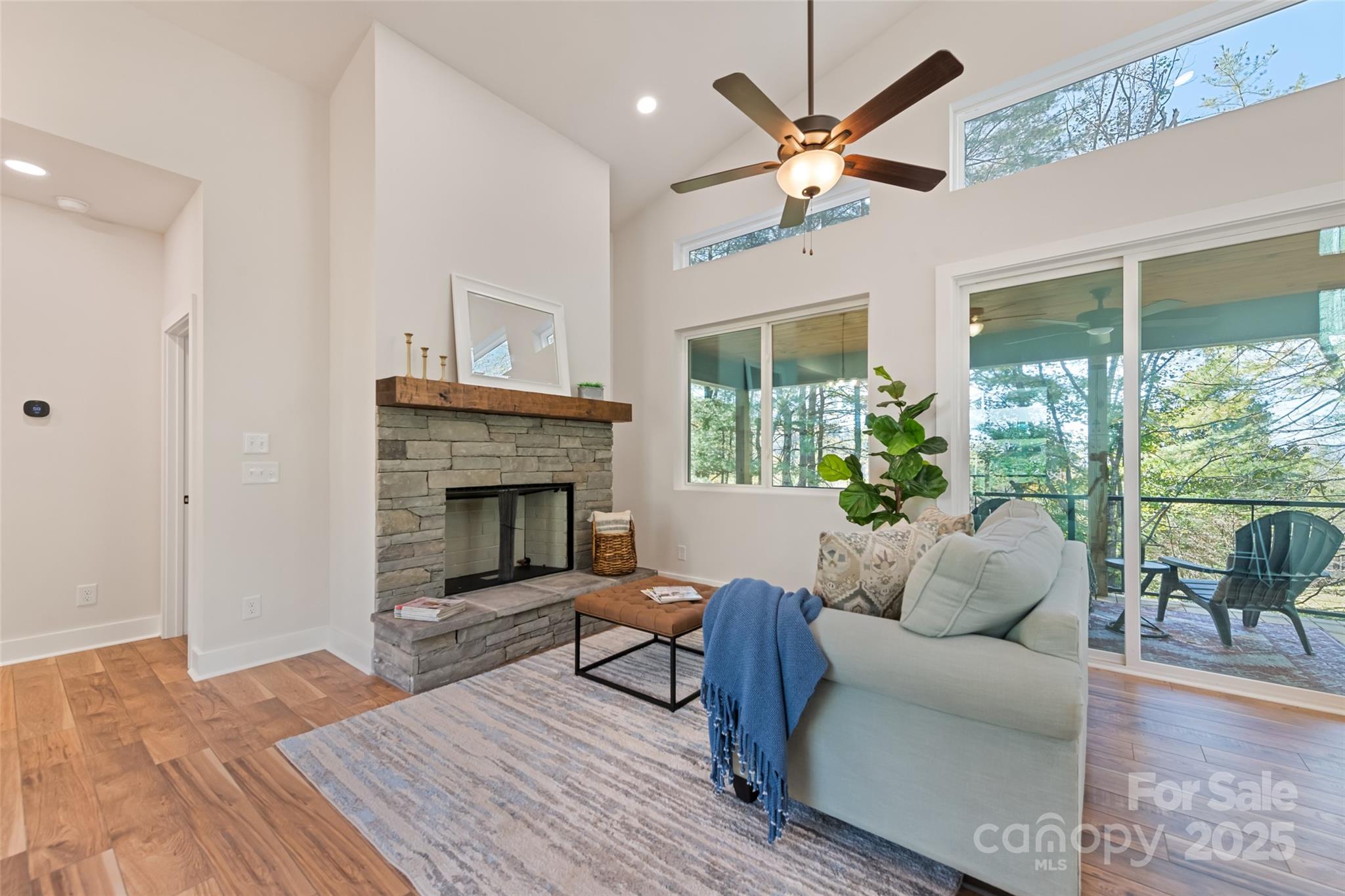 1807 Fisher Crk Road Sylva, NC 28779 - Photo 2 of 37 a living room with furniture a large window and a fireplace