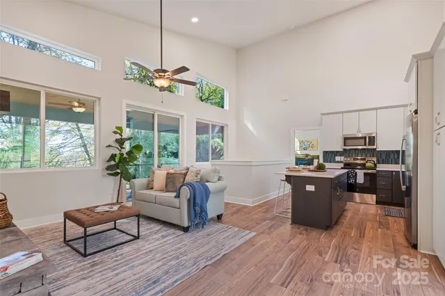 a living room with furniture dining table and a large window