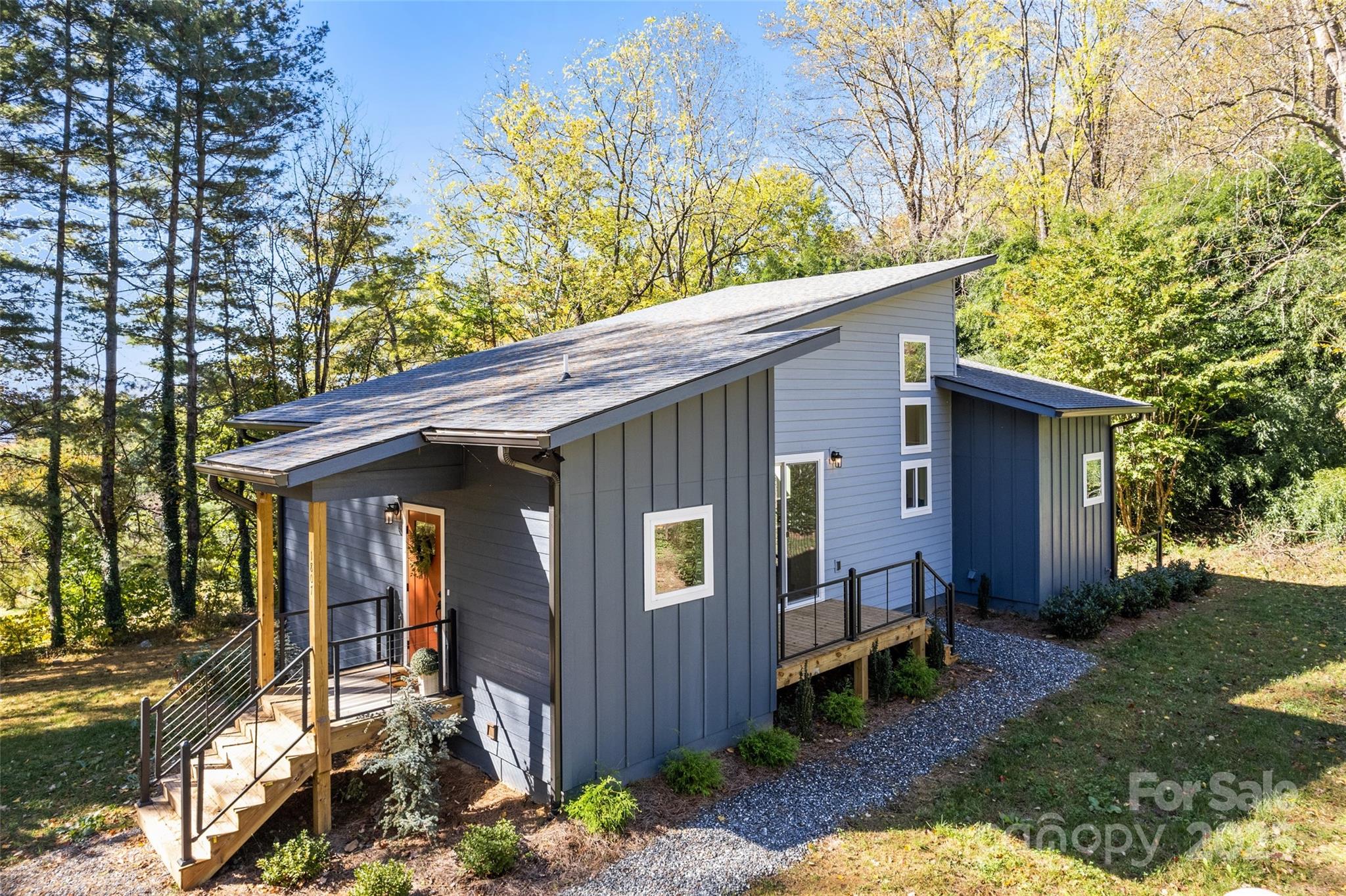 1807 Fisher Crk Road Sylva, NC 28779 - Photo 32 of 37 a view of a house with a yard chairs and table in a yard