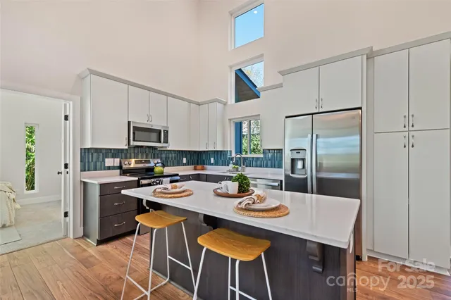 a kitchen with a dining table and chairs