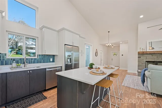 a open kitchen with stainless steel appliances kitchen island granite countertop a sink and cabinets
